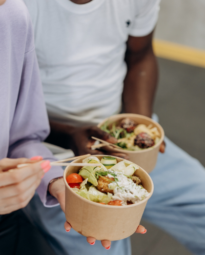 Woman and Man Eating A Bento Box Like Meal