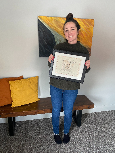 Reiki Master Holly Morris Holding her Cam's Kids Foundation Certificate of Appreciation