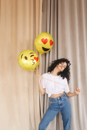 Girl Smiling with Emoji Balloons